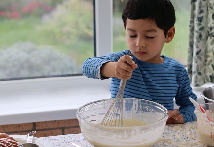 Child baking making cake batter
