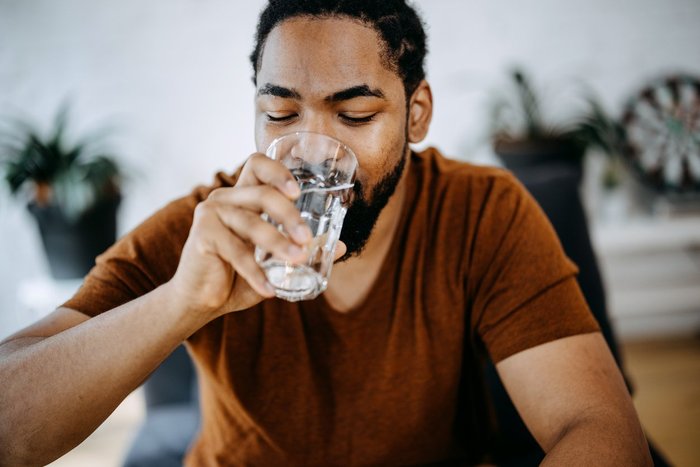 Man drinking water from a glass