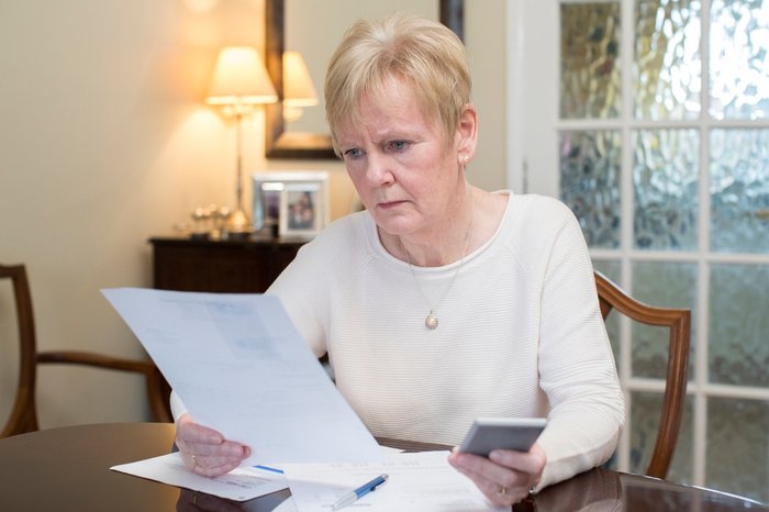 Woman concerned with bills and calculator