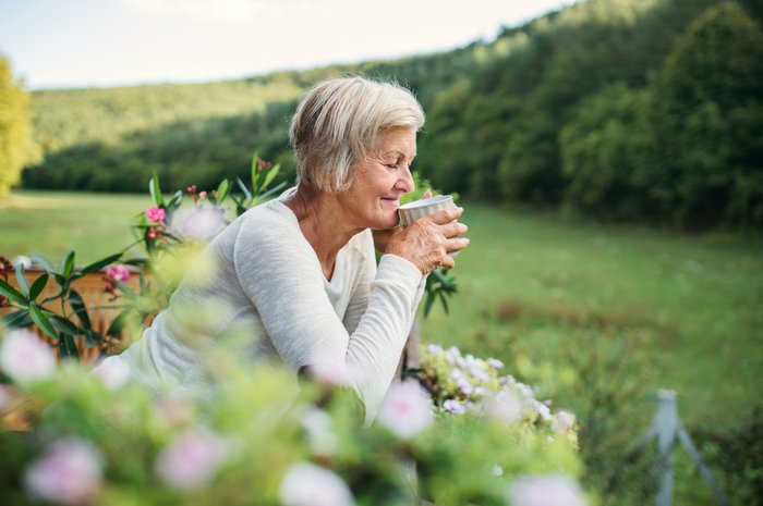 Woman drinking tea in the garden